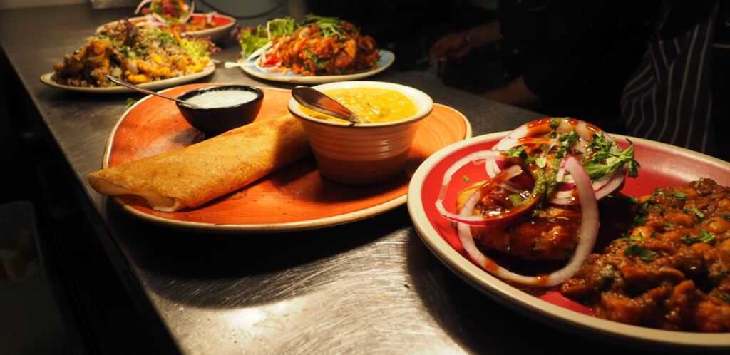 Five plates showing different food types available near Narrow Escape Rooms