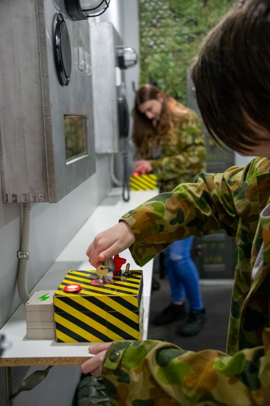 Teenagers launching missiles in Narrow Escape Rooms Launch room