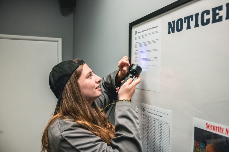 Teenager looking for clues in an escape room