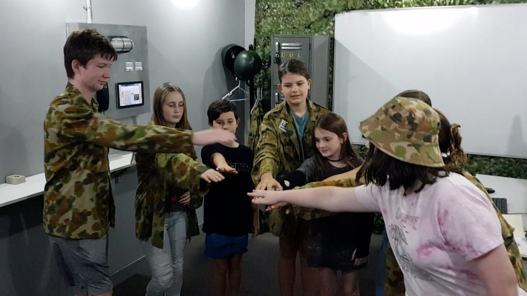 Kids celebrating their escape room success during the school holidays at Narrow Escape Rooms