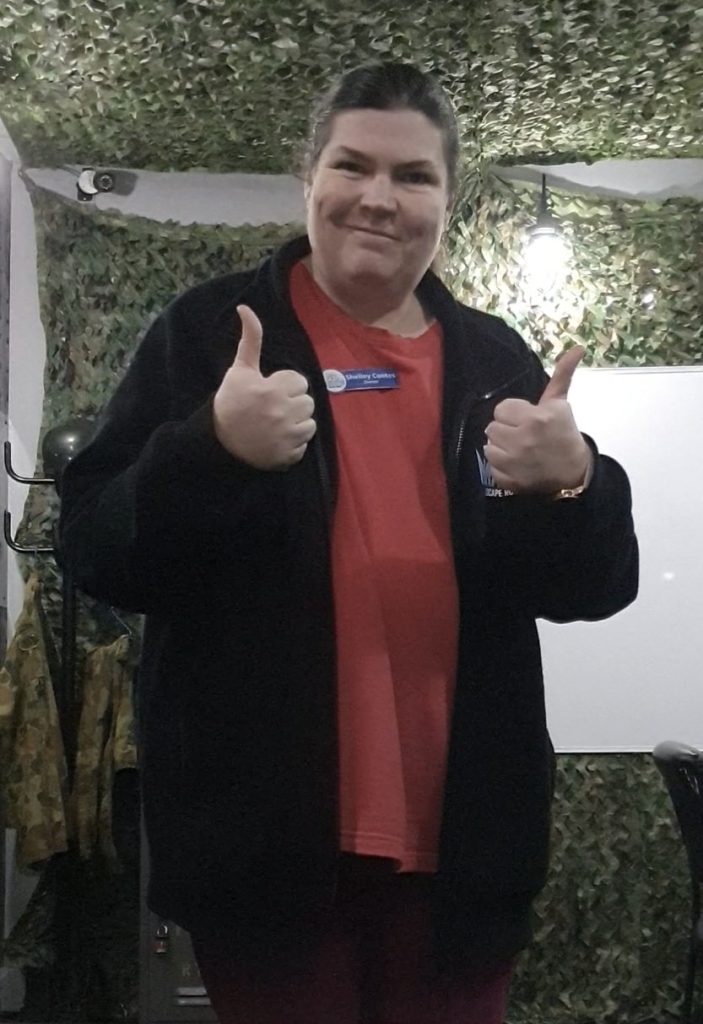 Shelley Cootes, owner of Narrow Escape Rooms Penrith, smiling and giving a thumbs-up after sharing escape room tips.
