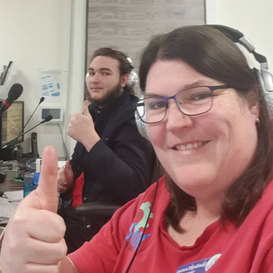 Game Masters at Narrow Escape Rooms Penrith monitoring an escape room game and giving a thumbs up