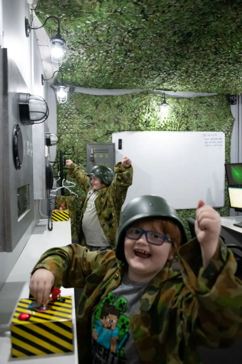 Kids celebrating after launching the Missiles and saving the world in Narrow Escape Rooms' Launch escape room.